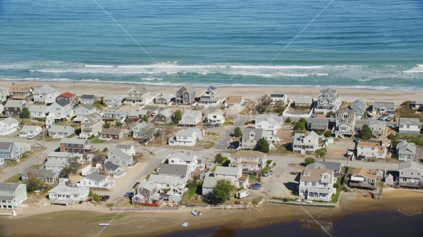 A group of oceanfront homes near ocean waves crashing, Humarock, Massachusetts Aerial Stock Photo AX143_053.0000266 | Axiom Images