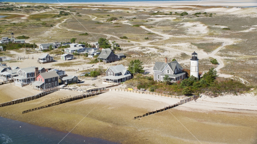 Sandy Neck Colony homes beside Sandy Neck Light, Cape Cod, Barnstable, Massachusetts Aerial Stock Photo AX143_145.0000000 | Axiom Images