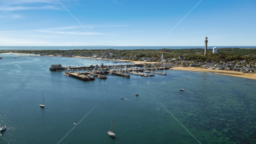 Boats docked at piers beside a small coastal town, Provincetown, Massachusetts Aerial Stock Photo AX143_222.0000000 | Axiom Images