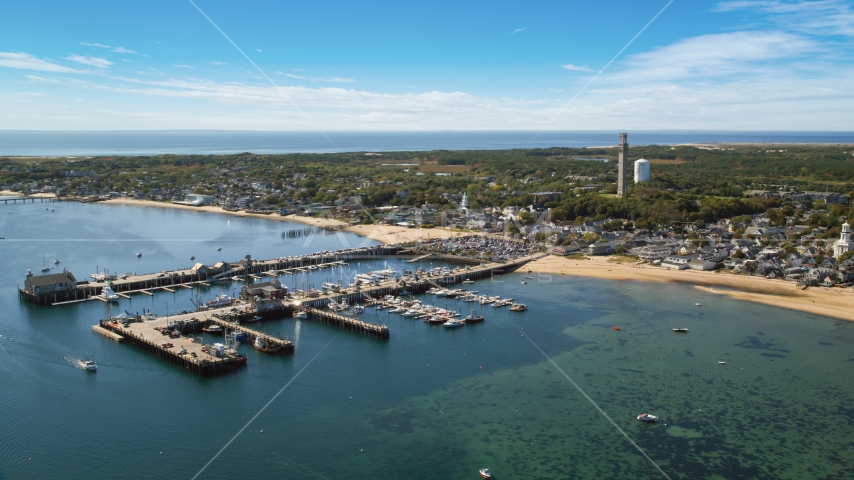 A small coastal town seen from near piers in the bay, Provincetown, Massachusetts Aerial Stock Photo AX143_231.0000282 | Axiom Images