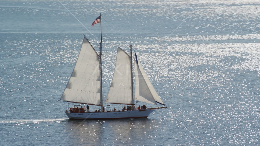 A sailing boat with a crowd of people on Cape Cod Bay, Massachusetts Aerial Stock Photo AX143_243.0000106 | Axiom Images