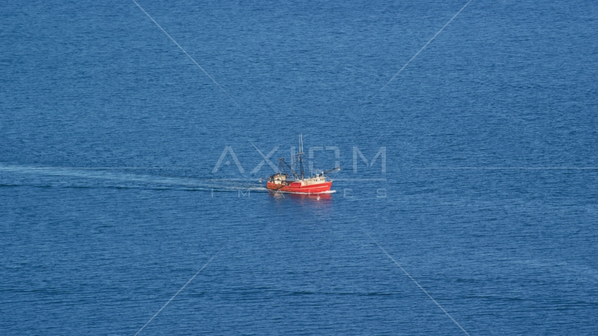 A fishing boat sailing on the Atlantic Ocean Aerial Stock Photo AX144_181.0000000 | Axiom Images