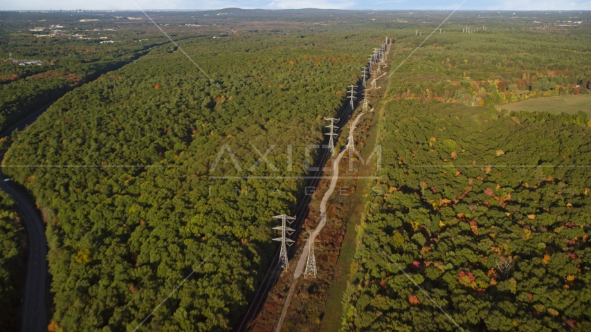 Power lines through deciduous forest in autumn, Walpole, Massachusetts Aerial Stock Photo AX145_125.0000000 | Axiom Images
