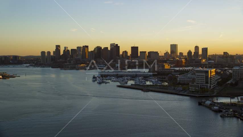 The city skyline of Downtown Boston seen from the Charles River, Massachusetts, sunset Aerial Stock Photo AX146_076.0000282F | Axiom Images