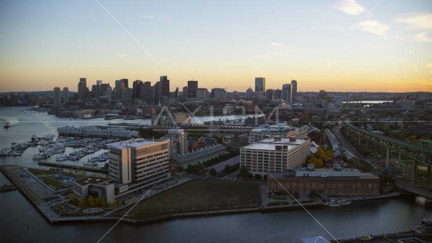 Office buildings in Charlestown, Massachusetts at sunset, and the Downtown Boston skyline Aerial Stock Photo AX146_097.0000237F | Axiom Images