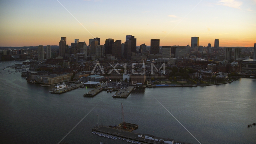 The city's downtown skyline at twilight, seen from the water, Downtown Boston, Massachusetts Aerial Stock Photo AX146_108.0000359F | Axiom Images