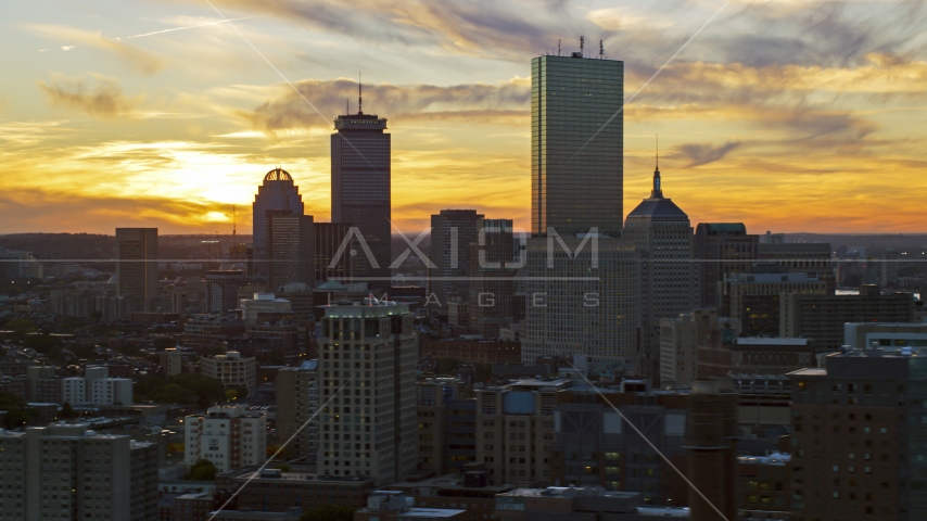 The city's downtown skyscrapers with the setting sun in the background, Downtown Boston, Massachusetts Aerial Stock Photo AX146_113.0000032F | Axiom Images