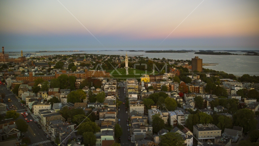 A view of of Dorchester Heights Monument and row houses in South Boston, Massachusetts, twilight Aerial Stock Photo AX146_116.0000187F | Axiom Images