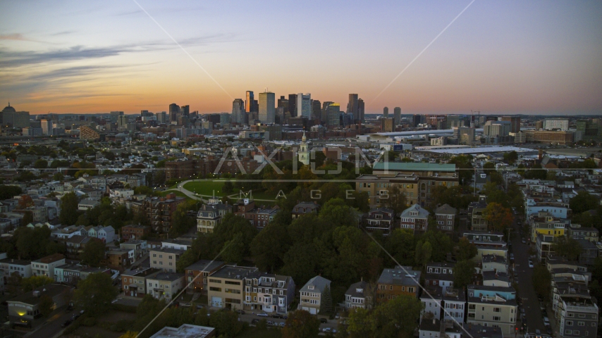 Dorchester Heights Monument in South Boston at twilight and the Downtown Boston skyline, Massachusetts Aerial Stock Photo AX146_120.0000325F | Axiom Images