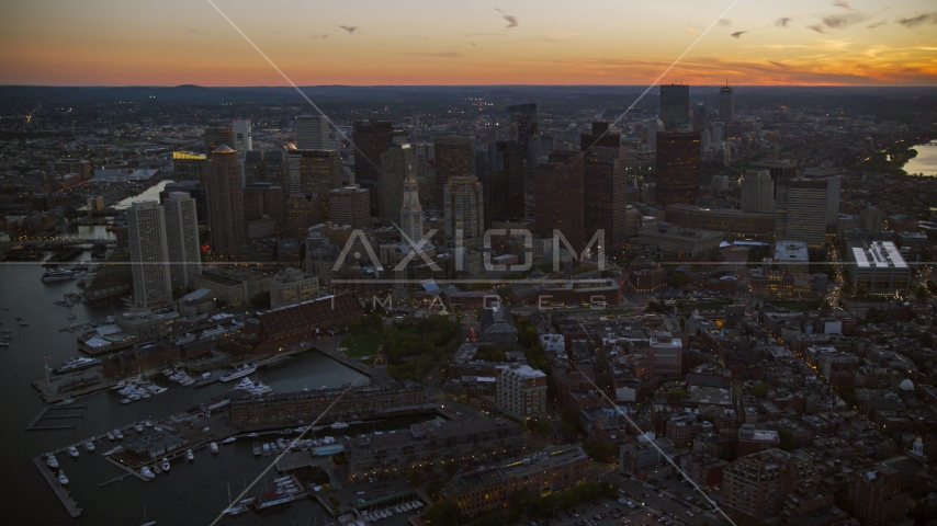 A wide view of skyscrapers and city buildings in Downtown Boston, Massachusetts, twilight Aerial Stock Photo AX146_129.0000272F | Axiom Images
