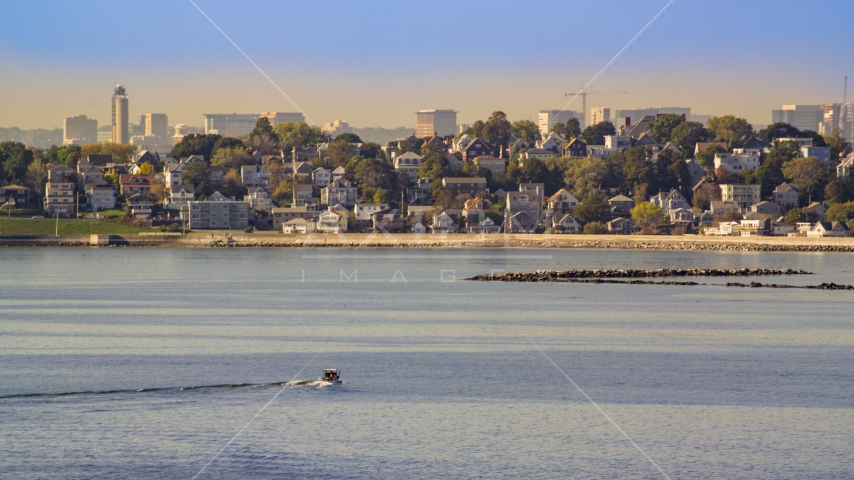 A fishing boat on Broad Sound near waterfront homes, Revere, Massachusetts Aerial Stock Photo AX147_015.0000241 | Axiom Images