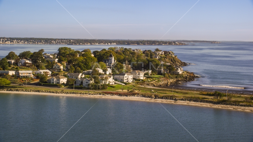 Coastal community nestled by trees on a peninsula in the bay, Nahant, Massachusetts Aerial Stock Photo AX147_016.0000235 | Axiom Images