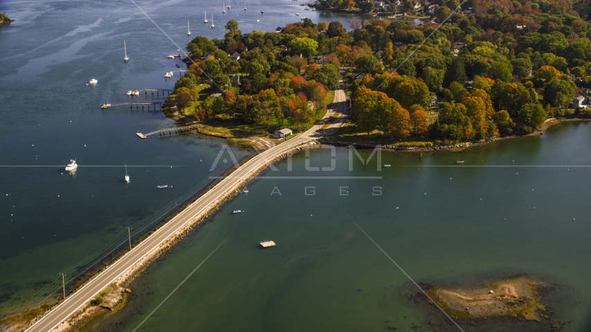 A small bridge leading to coastal homes in autumn, New Castle, New Hampshire Aerial Stock Photo AX147_189.0000000 | Axiom Images