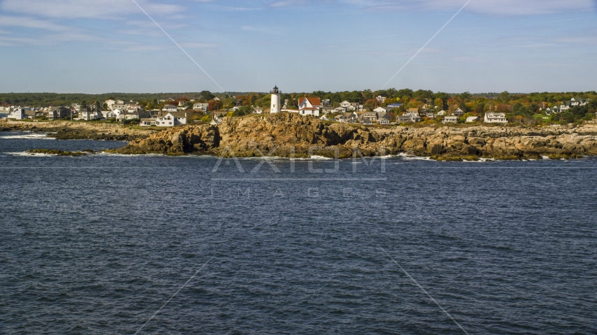The Cape Neddick Light with the town behind it in autumn, York, Maine Aerial Stock Photo AX147_240.0000000 | Axiom Images