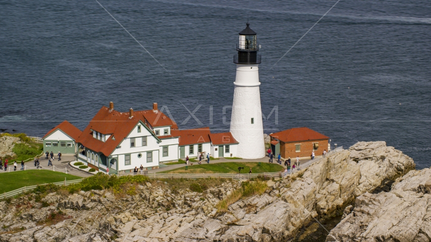 The Portland Head Light on a rocky shore overlooking the ocean in autumn, Cape Elizabeth, Maine Aerial Stock Photo AX147_315.0000249 | Axiom Images
