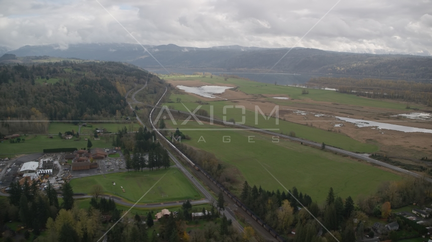 A train traveling by fields and country road in Washougal, Washington Aerial Stock Photo AX153_177.0000000F | Axiom Images