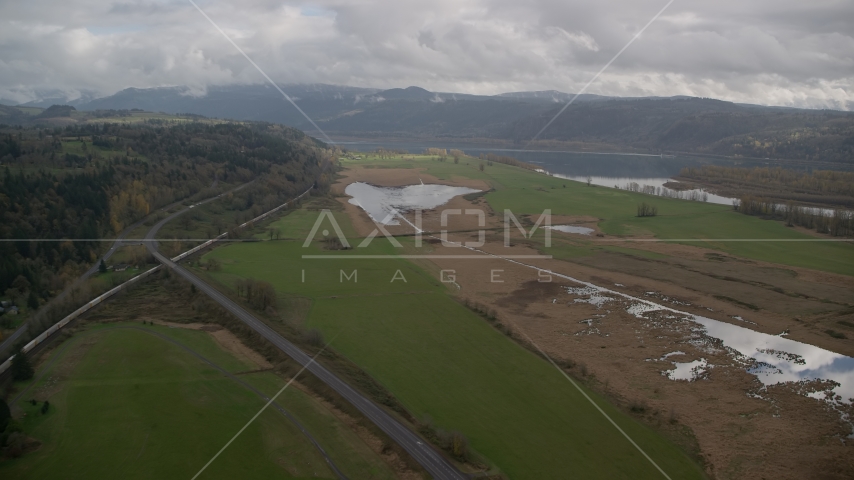 Train traveling by fields in Washougal, Washington Aerial Stock Photo AX153_177.0000272F | Axiom Images