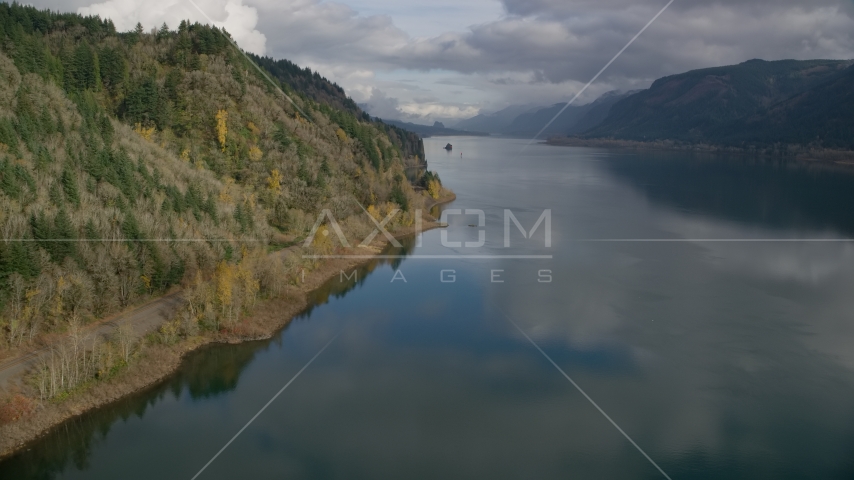 Railroad tracks at the bottom of a cliff in the Columbia River Gorge, Oregon Aerial Stock Photo AX154_001.0000308F | Axiom Images