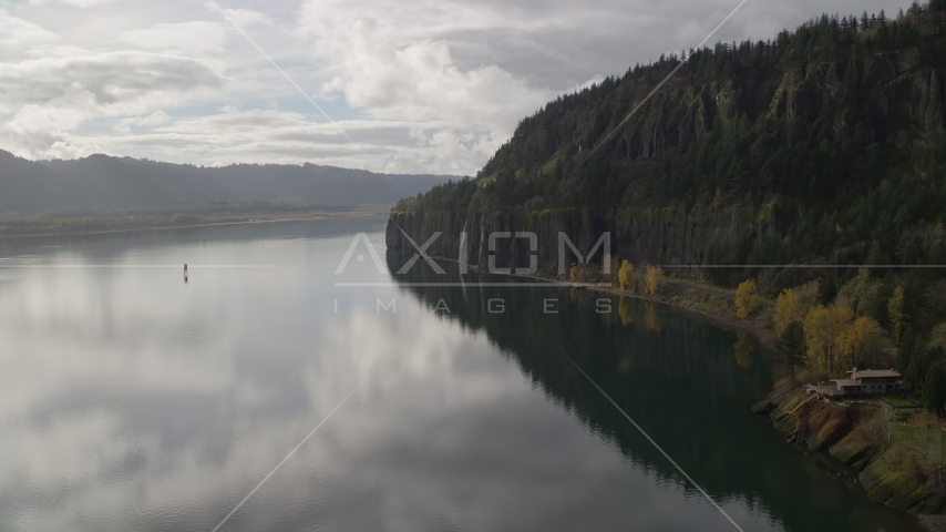 An isolated home overlooking the river in Columbia River Gorge, Washington Aerial Stock Photo AX154_008.0000156F | Axiom Images