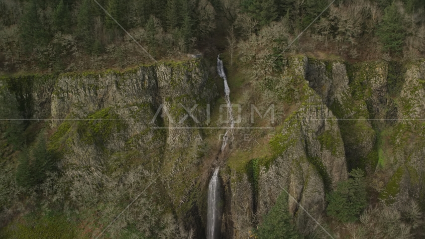 A waterfall on a steep cliff in Columbia River Gorge, Washington Aerial Stock Photo AX154_011.0000174F | Axiom Images