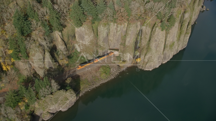 A train leaving Cape Horn Railroad Tunnel in Columbia River Gorge, Washington Aerial Stock Photo AX154_013.0000254F | Axiom Images