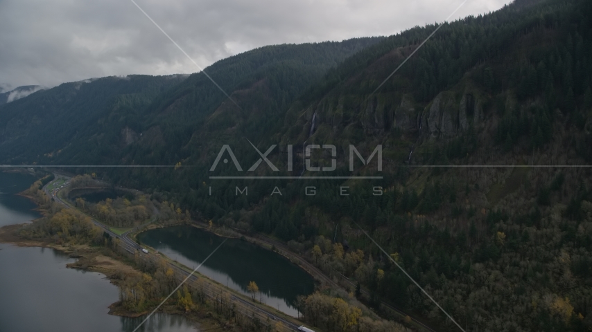 A waterfall on a Columbia River Gorge cliff in Multnomah County, Oregon Aerial Stock Photo AX154_017.0000351F | Axiom Images