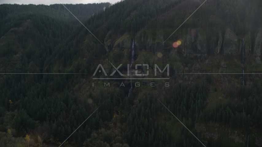 Waterfall on a Columbia River Gorge cliff face in Multnomah County, Oregon Aerial Stock Photo AX154_018.0000340F | Axiom Images