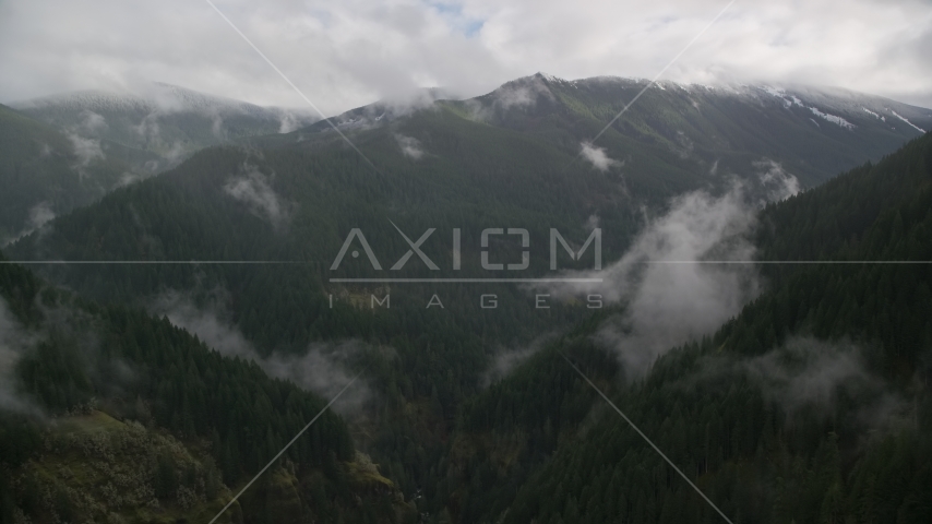 A misty canyon and a mountain ridge with light snow in Cascade Range, Hood River County, Oregon Aerial Stock Photo AX154_052.0000243F | Axiom Images