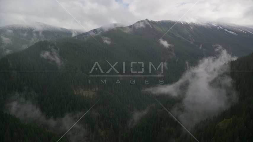 A mountain ridge with light snow at the end of a misty canyon in Cascade Range, Hood River County, Oregon Aerial Stock Photo AX154_052.0000388F | Axiom Images