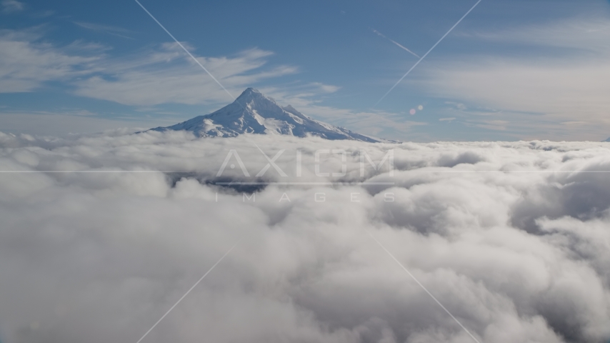 The snowy summit of Mount Hood above the clouds, Cascade Range, Oregon Aerial Stock Photo AX154_064.0000250F | Axiom Images
