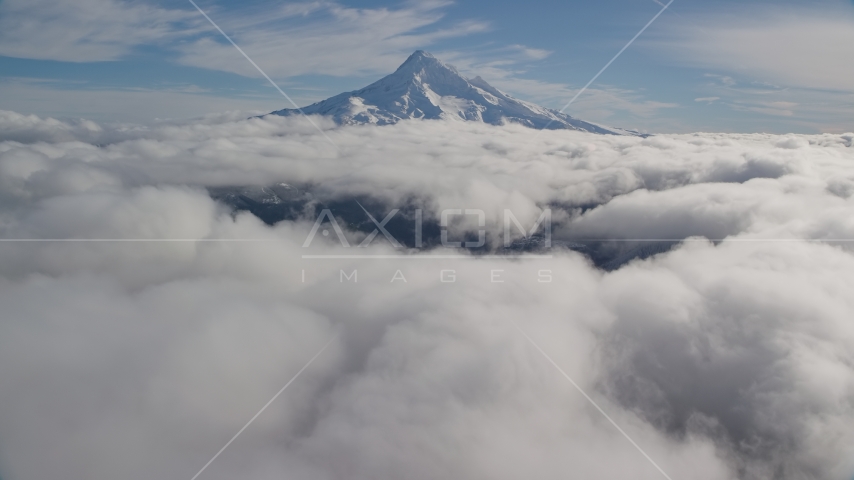 The snowy summit of Mount Hood and low clouds in the Cascade Range, Oregon Aerial Stock Photo AX154_066.0000182F | Axiom Images