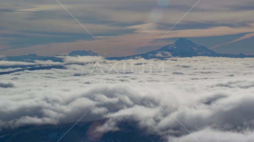 Mount Jefferson and Three Sisters Volcanoes, seen above the clouds, Cascade Range, Oregon Aerial Stock Photo AX154_099.0000300F | Axiom Images