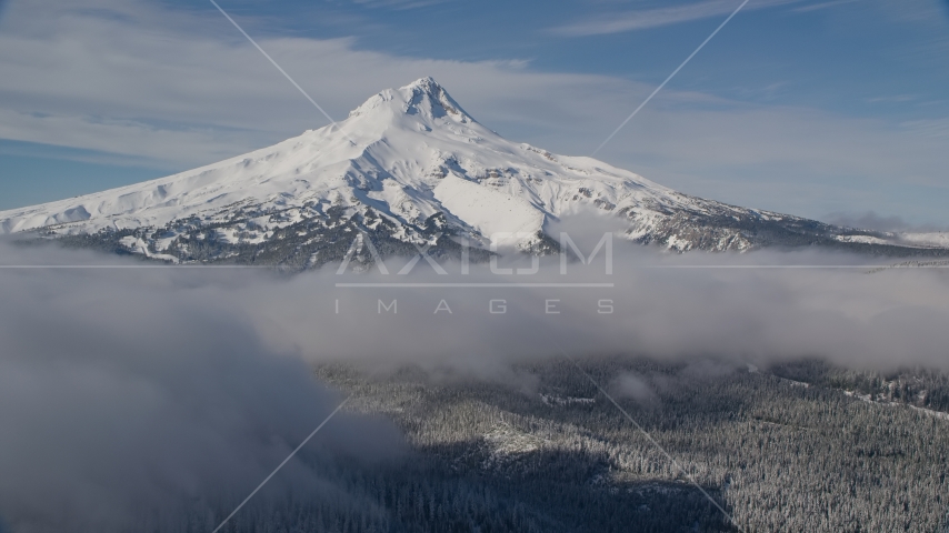 Snow-capped mountain peak and low clouds, Mount Hood, Cascade Range, Oregon Aerial Stock Photo AX154_117.0000237F | Axiom Images