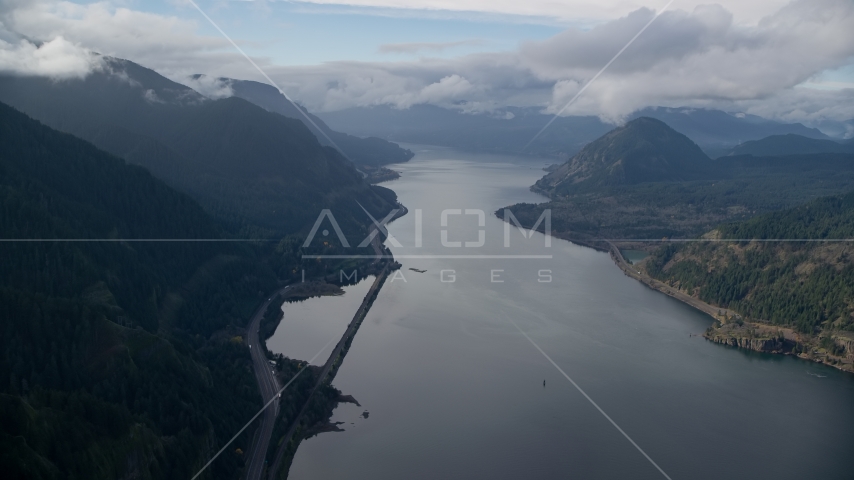 The I-84 highway at the base of mountains in Columbia River Gorge Aerial Stock Photo AX154_156.0000000F | Axiom Images