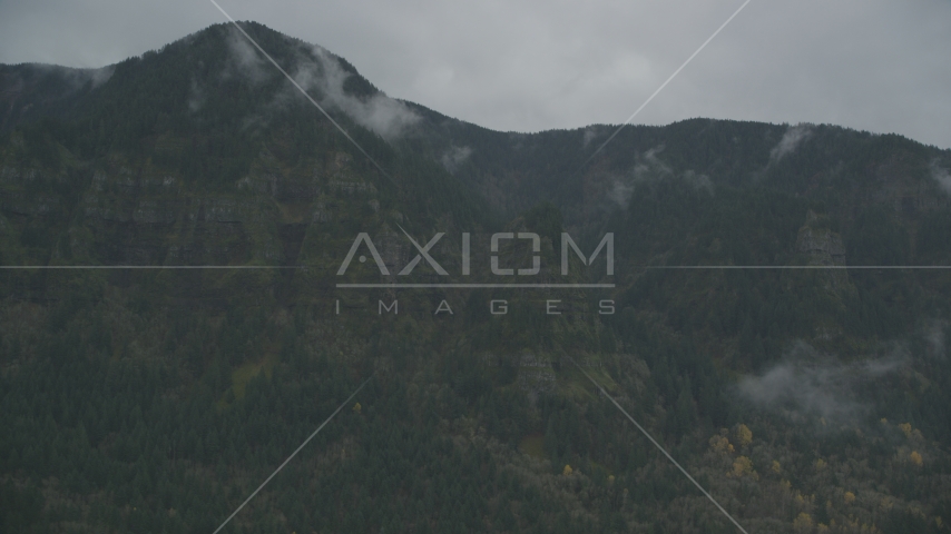 Rugged mountain cliffs and misty clouds on the Oregon side of Columbia River Gorge Aerial Stock Photo AX154_185.0000000F | Axiom Images