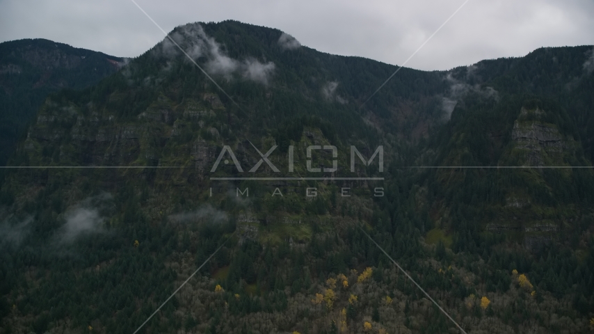 Rugged mountain cliffs and misty clouds on the Oregon side of Columbia River Gorge Aerial Stock Photo AX154_185.0000238F | Axiom Images