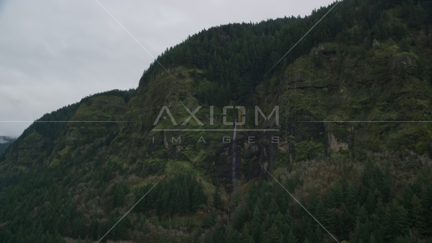 A waterfall on green cliffs on the Oregon side of Columbia River Gorge Aerial Stock Photo AX154_187.0000212F | Axiom Images