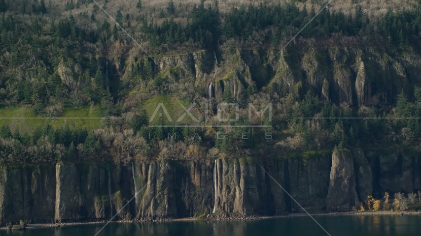 Waterfalls and steep green cliffs on the Washington side of Columbia River Gorge Aerial Stock Photo AX154_193.0000228F | Axiom Images