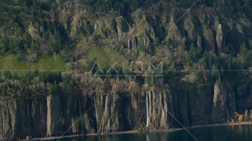 Four waterfalls on steep green cliffs on the Washington side of Columbia River Gorge Aerial Stock Photo AX154_194.0000136F | Axiom Images