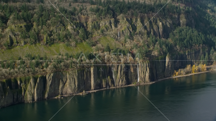 Four waterfalls on steep green cliffs and Columbia River on the Washington side of Columbia River Gorge Aerial Stock Photo AX154_195.0000000F | Axiom Images