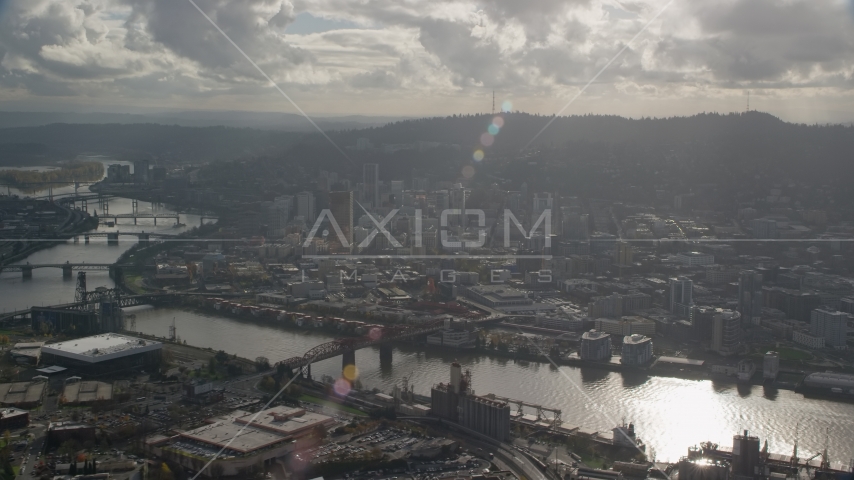 The Willamette River and Downtown Portland, Oregon with godrays shining down Aerial Stock Photo AX154_227.0000000F | Axiom Images
