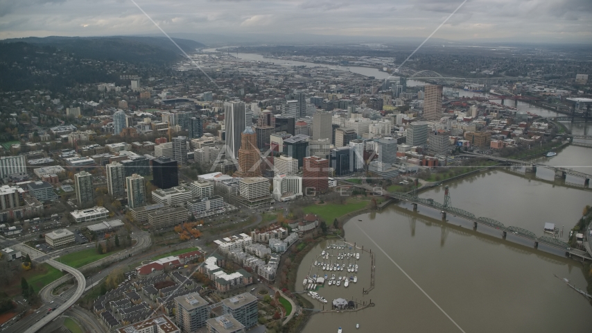 A view of Downtown Portland cityscape and waterfront park seen from the bridges over the Willamette River in Oregon Aerial Stock Photo AX155_094.0000000F | Axiom Images