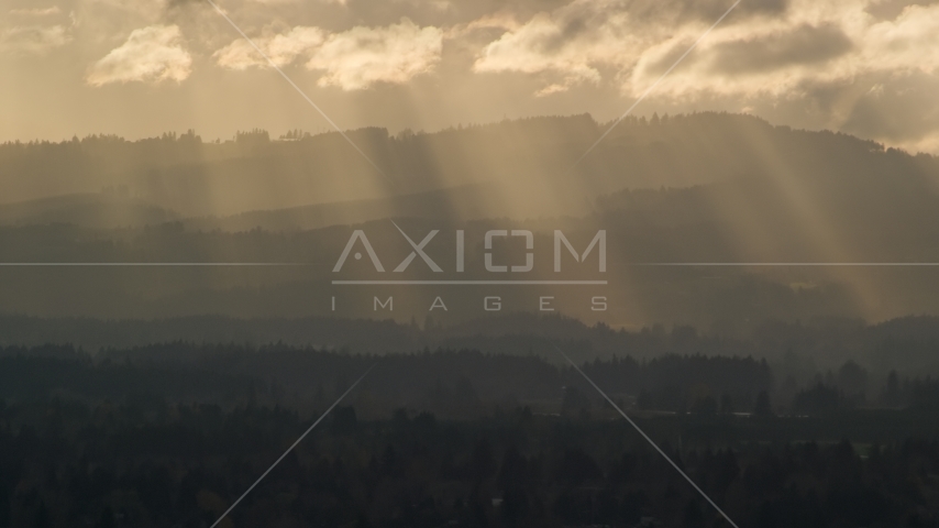 Godrays shining down on mountains near Beaverton, Oregon at sunset Aerial Stock Photo AX155_124.0000225F | Axiom Images