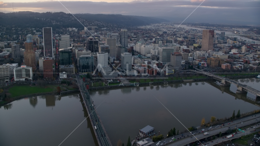 Downtown Portland skyscrapers and city park seen across the Willamette River at sunset Aerial Stock Photo AX155_153.0000126F | Axiom Images