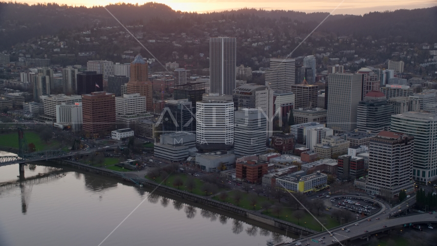 Downtown Portland skyscrapers and city park beside the Willamette River at sunset Aerial Stock Photo AX155_154.0000181F | Axiom Images