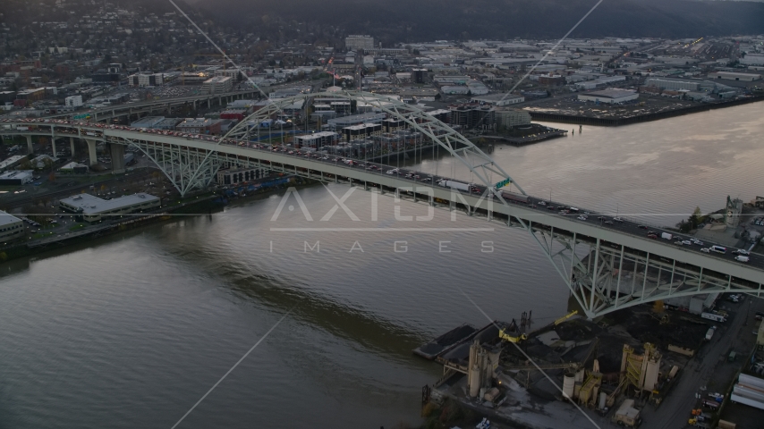 Heavy traffic crossing the Fremont Bridge at sunset in Downtown Portland, Oregon Aerial Stock Photo AX155_158.0000038F | Axiom Images