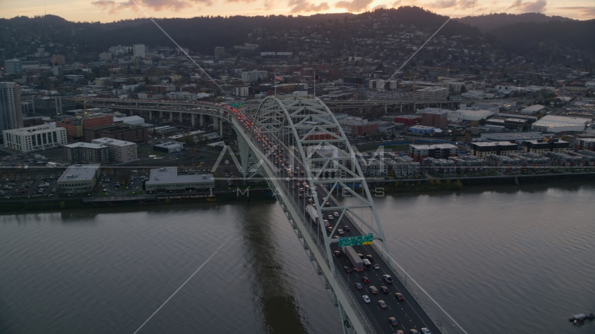 Heavy traffic crossing the Fremont Bridge at sunset in Downtown Portland, Oregon Aerial Stock Photo AX155_158.0000229F | Axiom Images