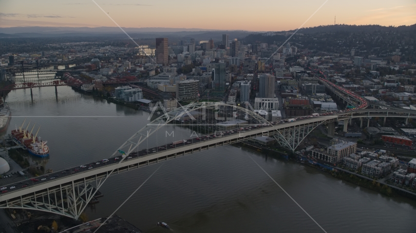Heavy traffic on the Fremont Bridge at sunset, Downtown Portland in the background, Oregon Aerial Stock Photo AX155_161.0000096F | Axiom Images