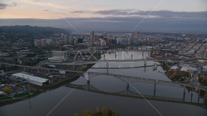 Downtown Portland and the Willamette River at sunset, seen from the Ross Island Bridge Aerial Stock Photo AX155_170.0000292F | Axiom Images