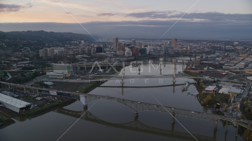 Willamette River and bridges with distant Downtown Portland at sunset, Oregon Aerial Stock Photo AX155_171.0000000F | Axiom Images